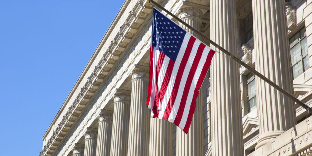 Department of Commerce in Washington Department of Commerce in Washington DC, America. American flag flying.