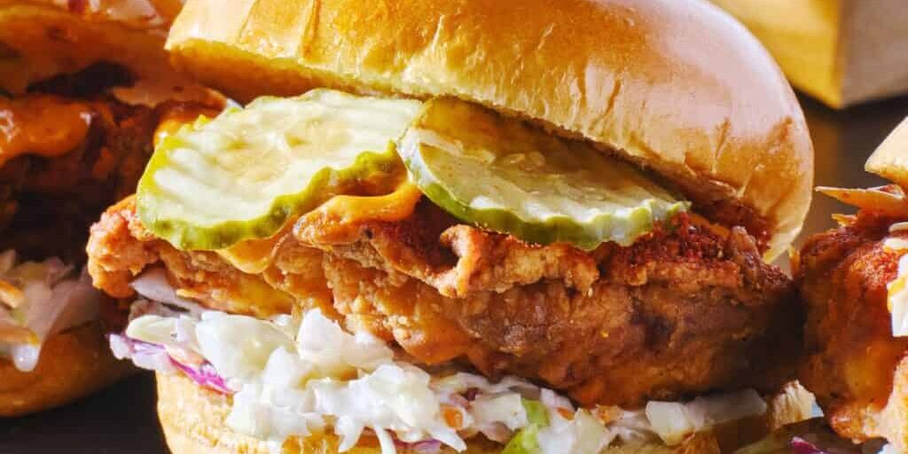 spicy nashville hot chicken sandwich with coleslaw and pickles
