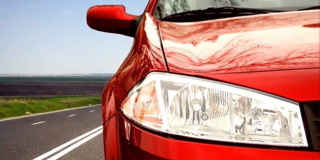 Red Sport car on a highway Green Sport car on a highway